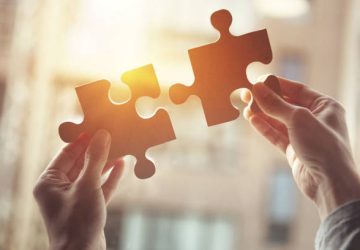 Businesswoman hand connecting jigsaw puzzle, Business solutions, success and strategy concept